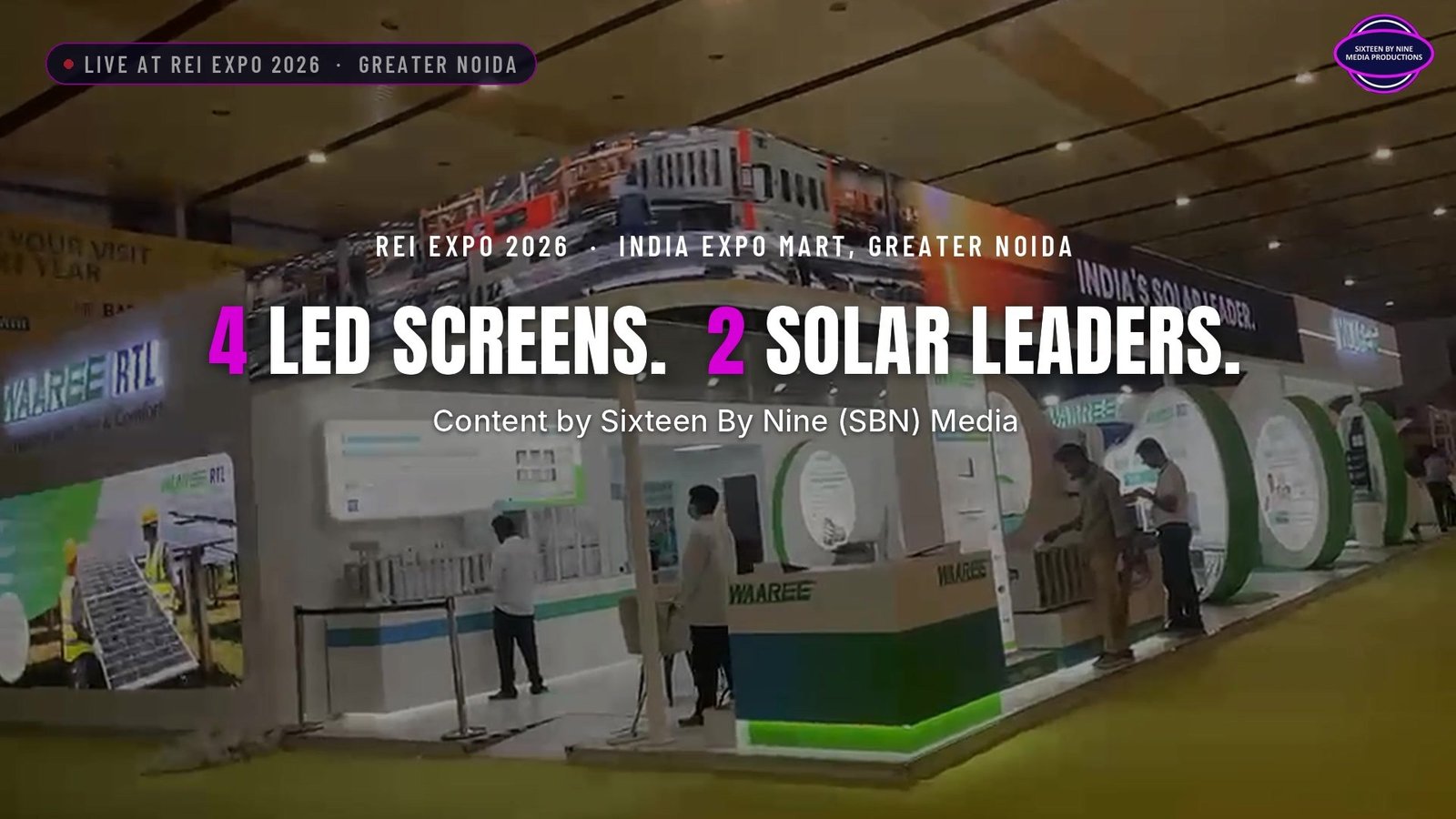 Waaree RTL stand at REI Expo 2026 with its 18 m LED fascia running above, four LED screens for two solar brands